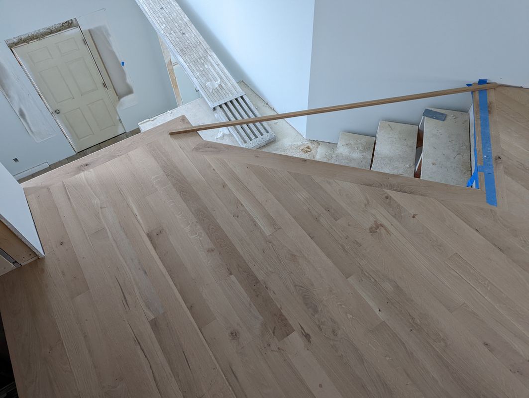 White oak installation at stair landing with diagonal layout