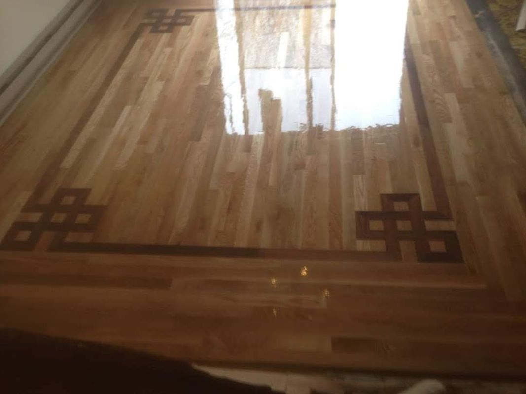 Decorative Celtic knot corner inlays with walnut border on oak